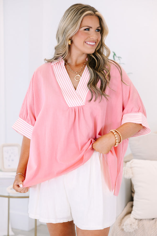 Plus Size pink v-neck top with striped trim on the collar and short sleeves.