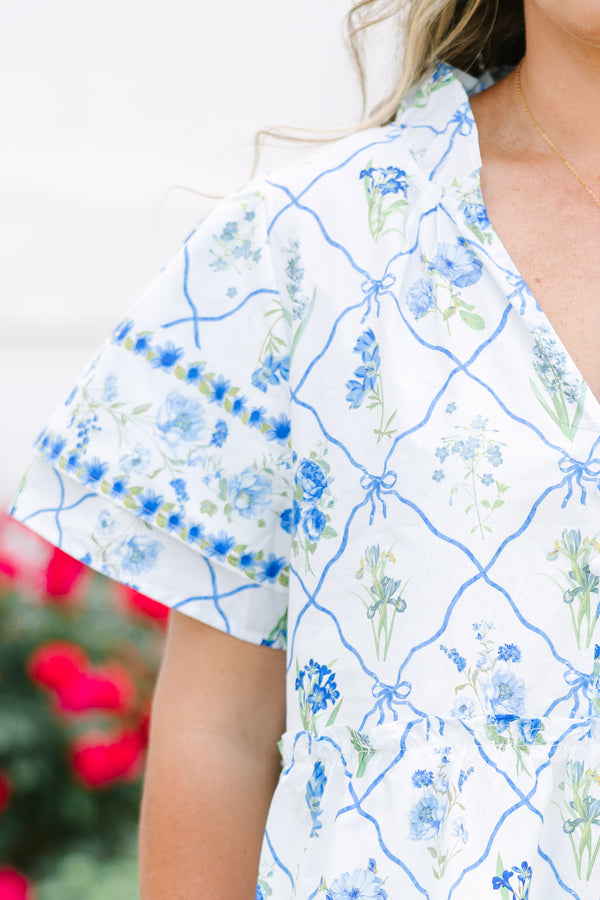 Chic Soul plus size clothing, white top with short sleeves that have a ruffle flare on the ends of the sleeves as well as a slight v-neckline and a blue and green block pattern throughout