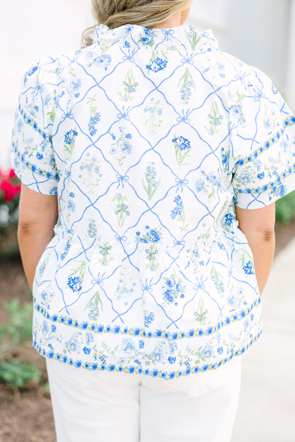 Chic Soul plus size clothing, white top with short sleeves that have a ruffle flare on the ends of the sleeves as well as a slight v-neckline and a blue and green block pattern throughout