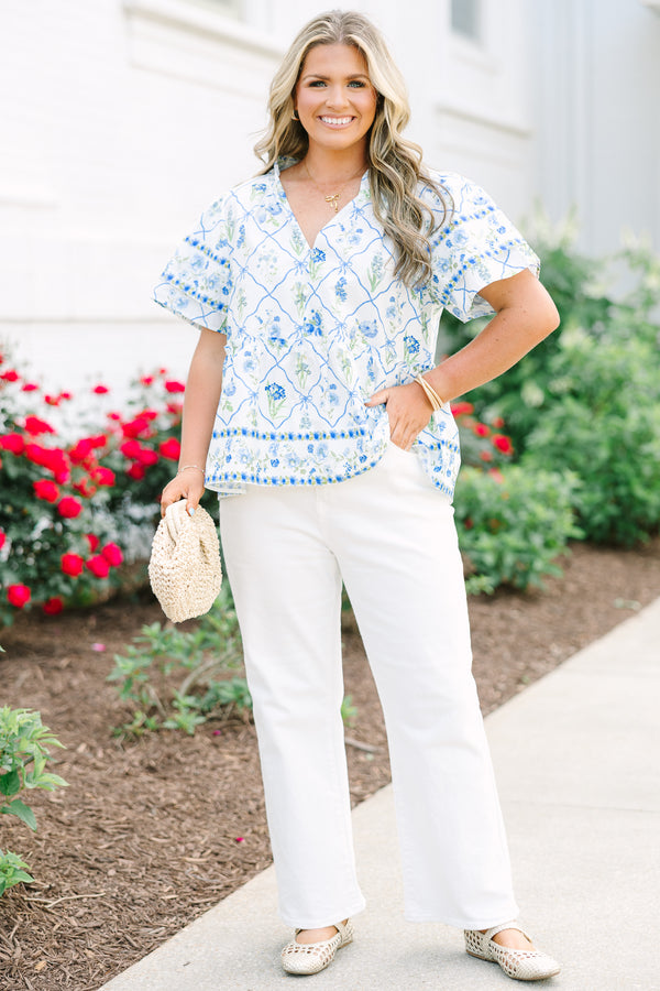 Chic Soul plus size clothing, white top with short sleeves that have a ruffle flare on the ends of the sleeves as well as a slight v-neckline and a blue and green block pattern throughout