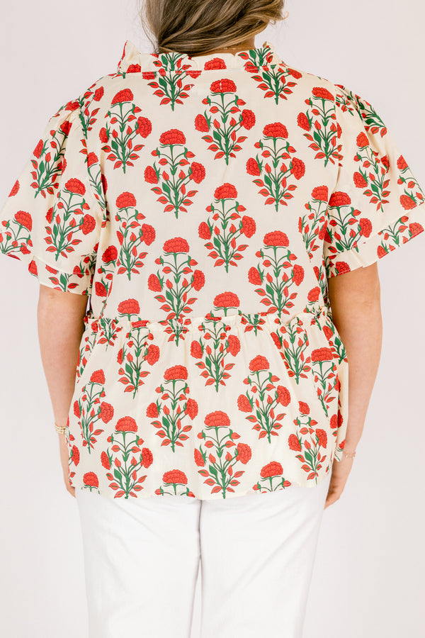 Chic Soul plus size clothing, white top with short sleeves that have a ruffle flare on the ends of the sleeves as well as a slight v-neckline and an abstract orange and green block pattern throughout