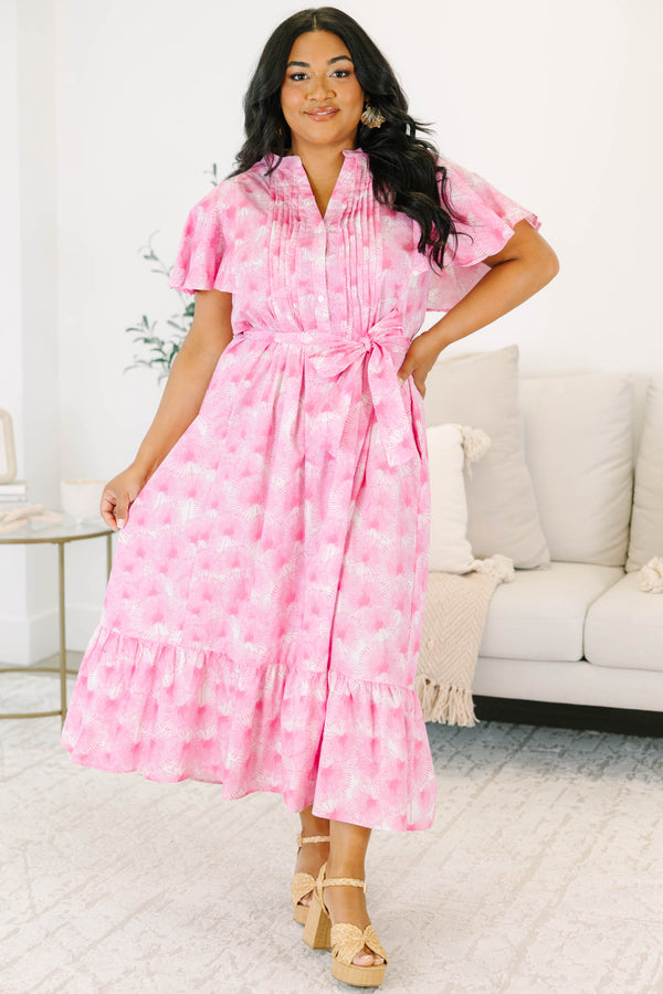 Plus size pink floral midi dress with ruffle sleeves, a tie waist, and flowy tiered skirt.
