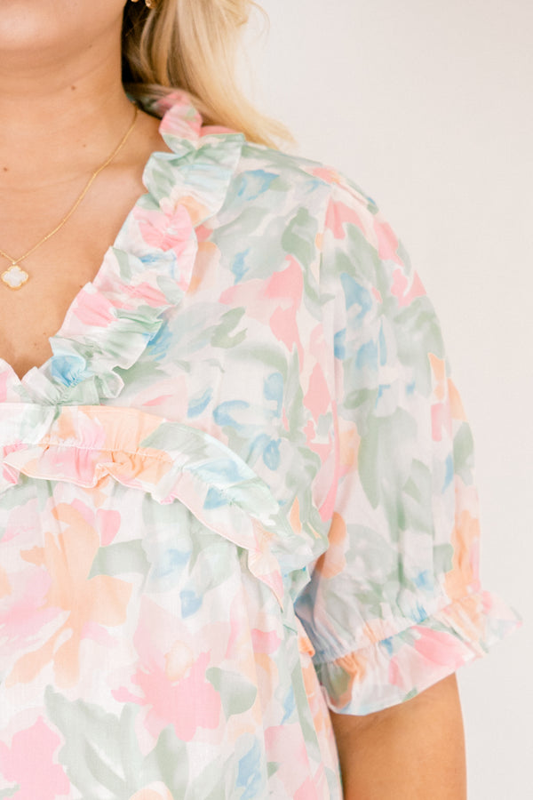 Chic Soul plus size clothing, peach floral top with short sleeves that have a cuffed ruffle detail on the bottom of both sleeves as well as ruffle details outlining the v-neckline and going under the chest area 