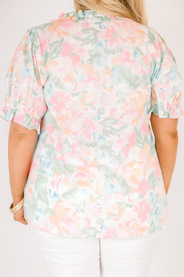 Chic Soul plus size clothing, peach floral top with short sleeves that have a cuffed ruffle detail on the bottom of both sleeves as well as ruffle details outlining the v-neckline and going under the chest area 