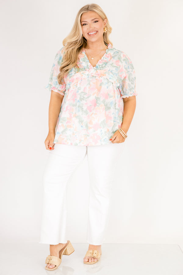 Chic Soul plus size clothing, peach floral top with short sleeves that have a cuffed ruffle detail on the bottom of both sleeves as well as ruffle details outlining the v-neckline and going under the chest area 