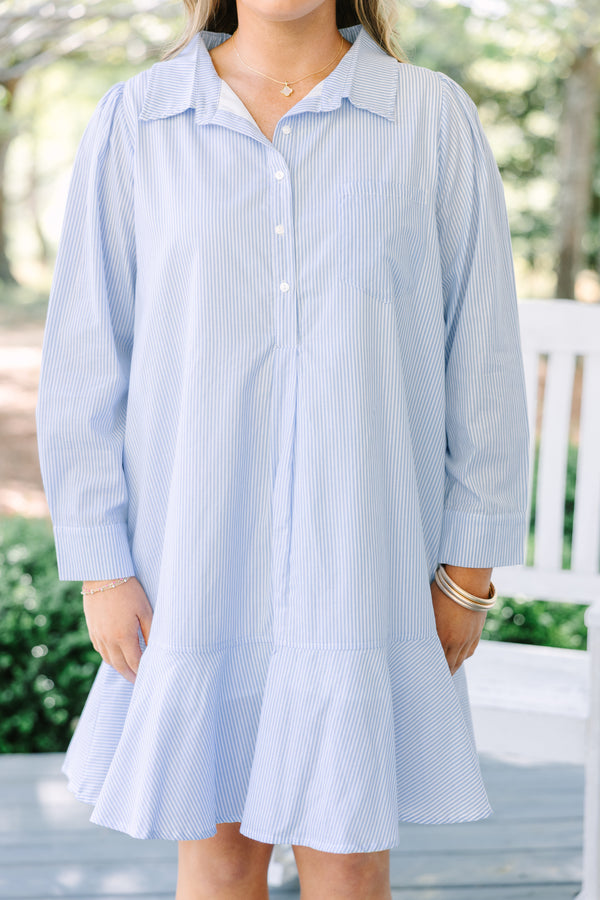 Chic soul plus size clothing, blue striped knee length dress with long sleeves and buttons going down the center of the dress with a ruffle flare at the end 
