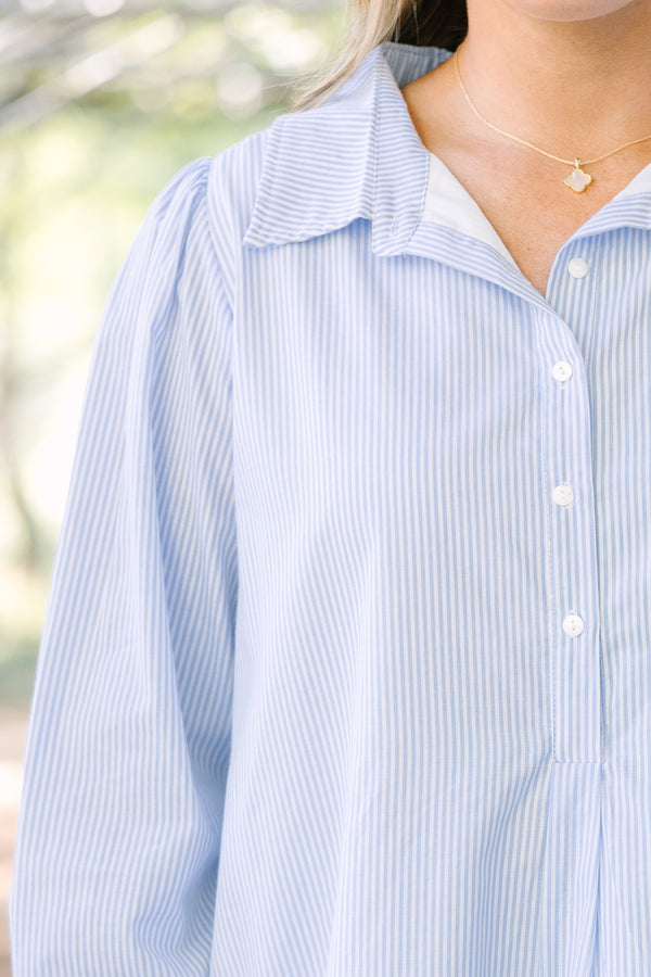 Chic soul plus size clothing, blue striped knee length dress with long sleeves and buttons going down the center of the dress with a ruffle flare at the end 
