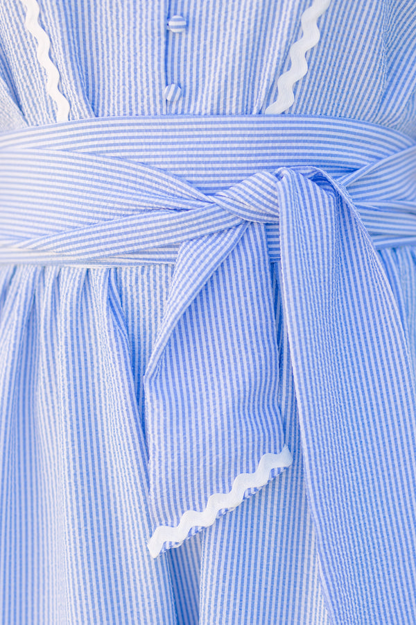 Chic Soul plus size clothing, blue sleeveless midi dress with collar, button down front, waist tie and white ricrac trim along the bottom of the dress and waist tie