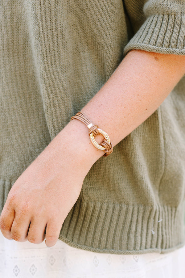Desert Darling Bracelet in brown featuring multi-strand cord and a gold oval ring clasp.