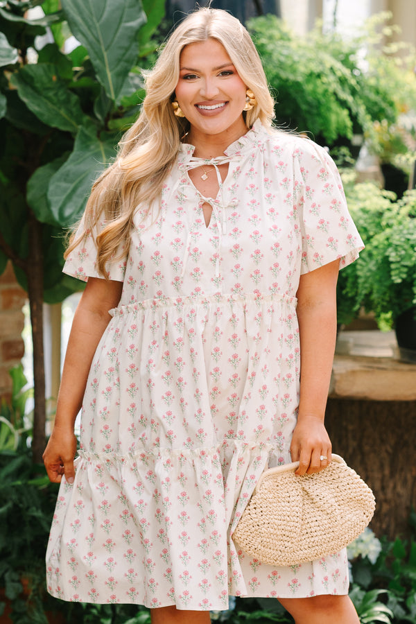 Chic Soul plus size clothing, cream tiered knee length dress with a pink floral pattern as well as two bows that tie  on the across the v-neckline 