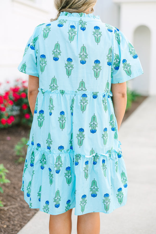 Chic Soul plus size clothing, light blue tiered knee length dress with a dark blue and green floral pattern as well as two bows that tie  on the across the v-neckline 