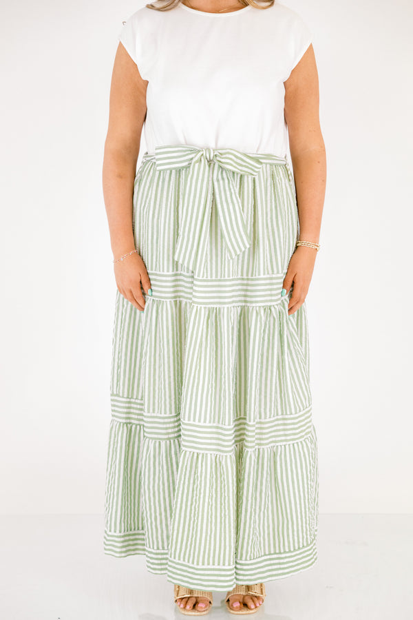 Chic Soul plus size clothing, maxi dress with a solid white short sleeve top and then a green striped skirt starting at the waist and going all the way down as well as a bow that ties around the waist 
