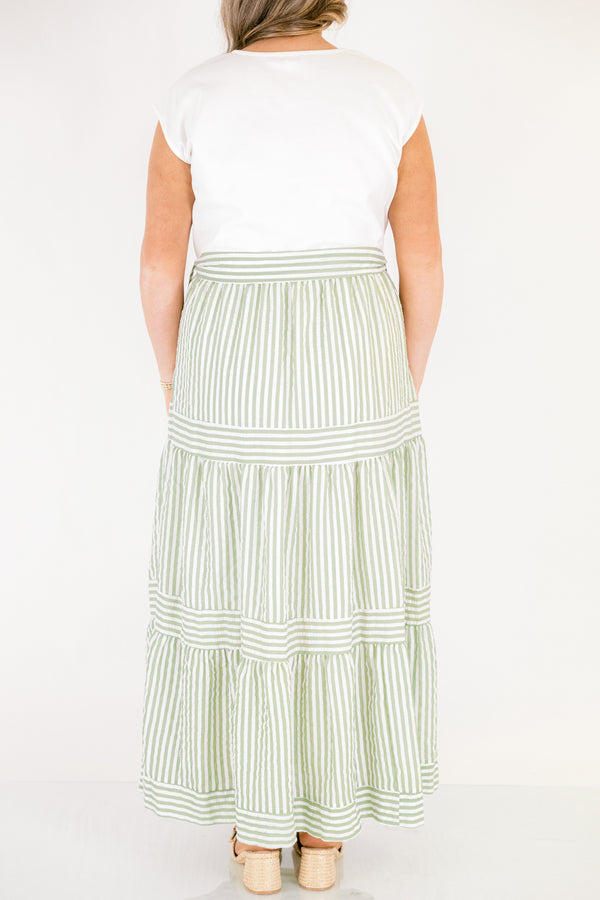 Chic Soul plus size clothing, maxi dress with a solid white short sleeve top and then a green striped skirt starting at the waist and going all the way down as well as a bow that ties around the waist 