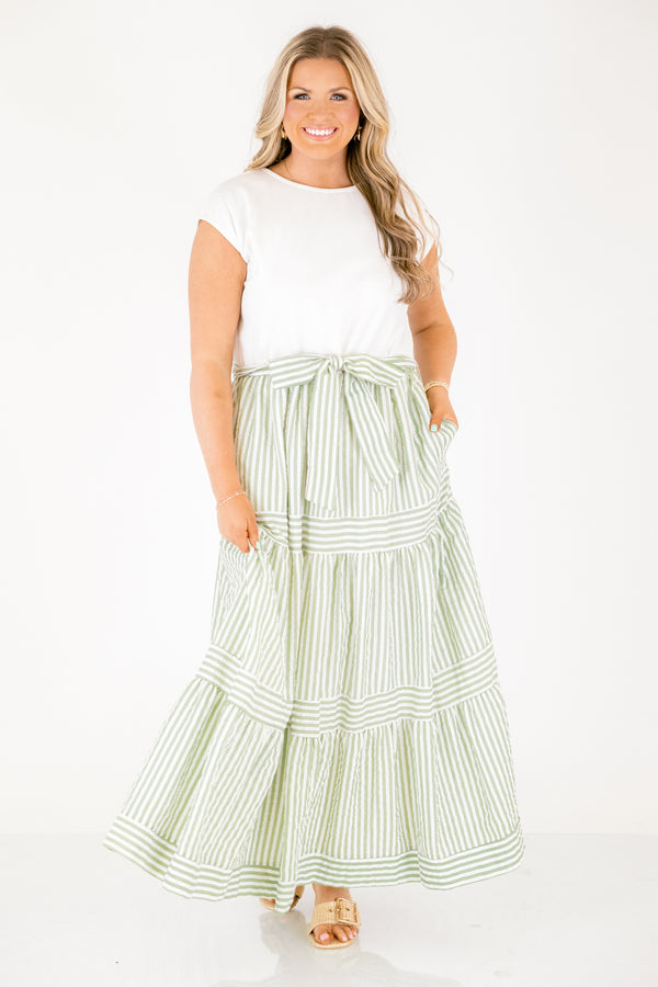 Chic Soul plus size clothing, maxi dress with a solid white short sleeve top and then a green striped skirt starting at the waist and going all the way down as well as a bow that ties around the waist 