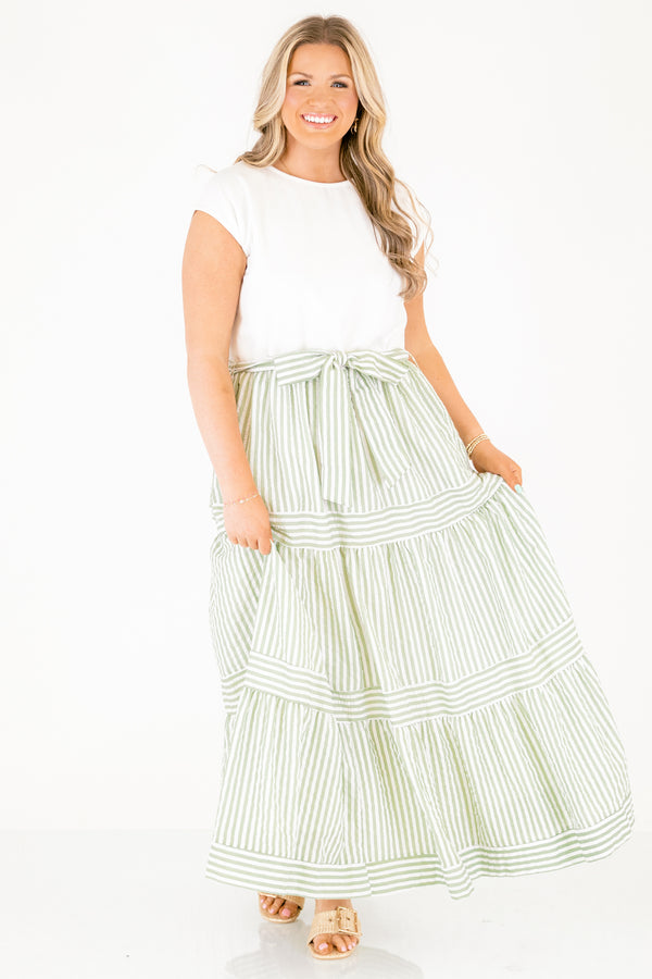 Chic Soul plus size clothing, maxi dress with a solid white short sleeve top and then a green striped skirt starting at the waist and going all the way down as well as a bow that ties around the waist 