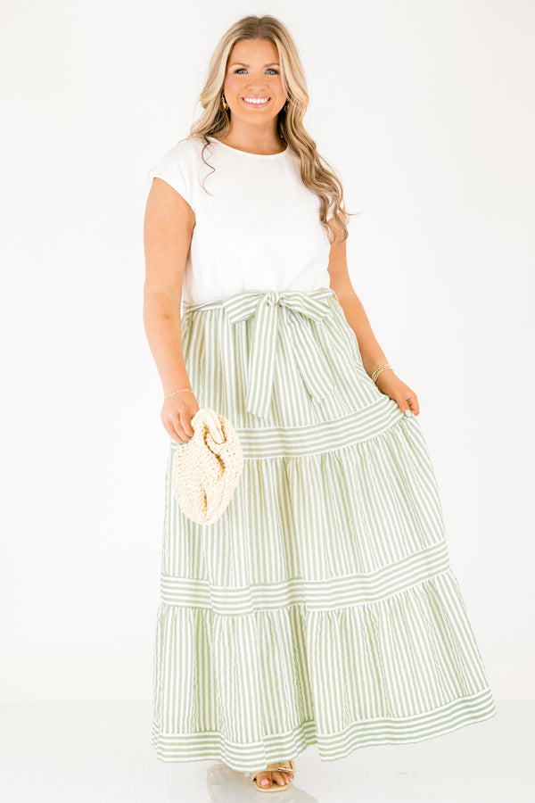 Chic Soul plus size clothing, maxi dress with a solid white short sleeve top and then a green striped skirt starting at the waist and going all the way down as well as a bow that ties around the waist 