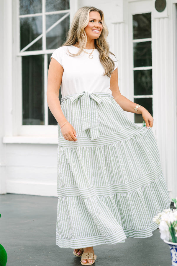 Chic Soul plus size clothing, maxi dress with a solid white short sleeve top and then a green striped skirt starting at the waist and going all the way down as well as a bow that ties around the waist 