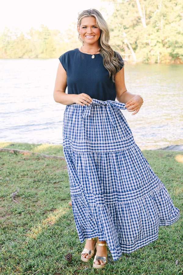 Plus size clothing, short sleeve tiered maxi dress with  a navy bodice and the skirt a navy blue and white gingham with a self-tie waist belt