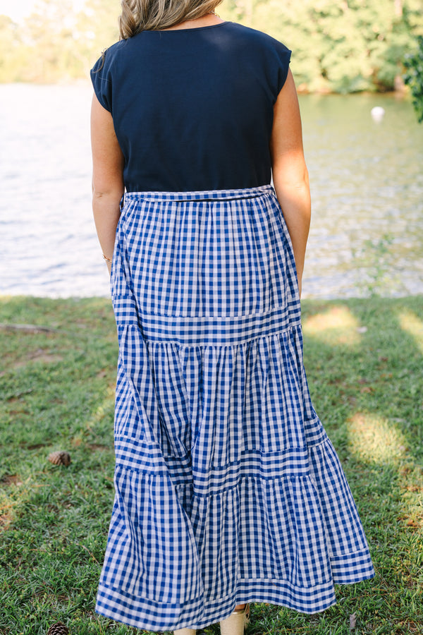 Plus size clothing, short sleeve tiered maxi dress with  a navy bodice and the skirt a navy blue and white gingham with a self-tie waist belt