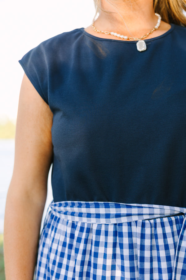 Plus size clothing, short sleeve tiered maxi dress with  a navy bodice and the skirt a navy blue and white gingham with a self-tie waist belt
