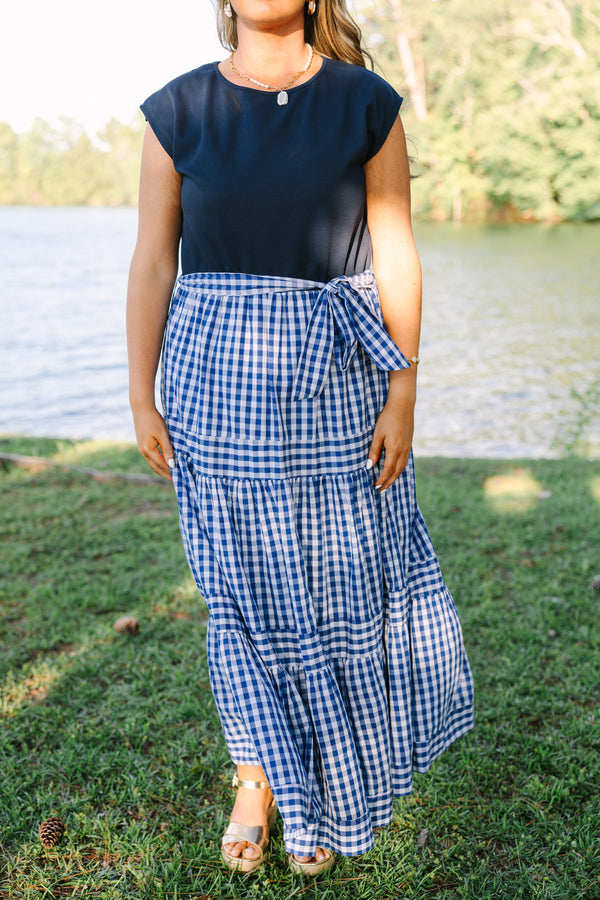 Plus size clothing, short sleeve tiered maxi dress with  a navy bodice and the skirt a navy blue and white gingham with a self-tie waist belt