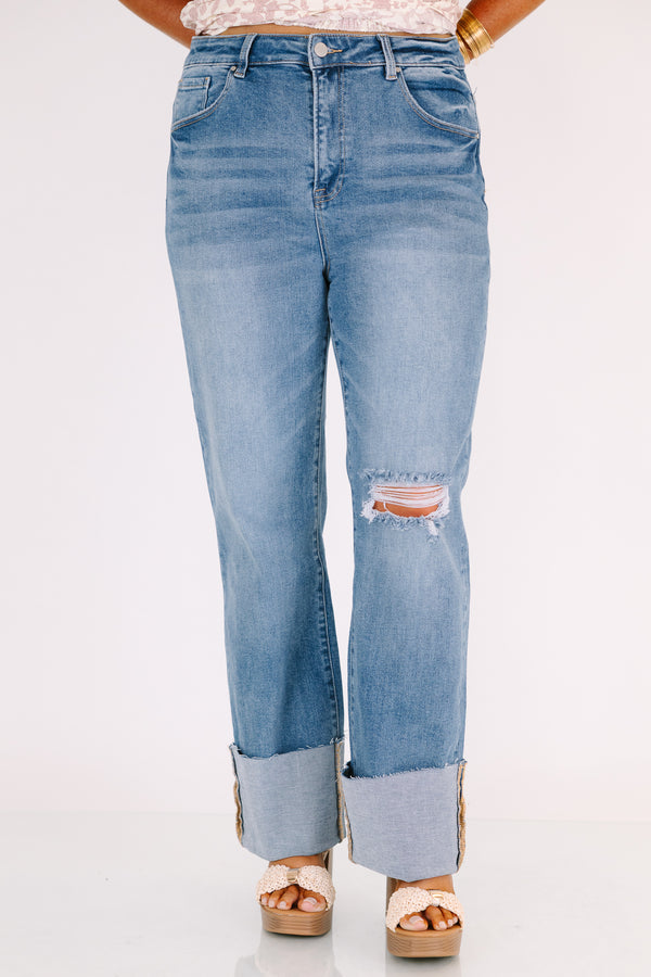 Chic Soul plus size clothing, a wide leg jean in a medium wash featuring thick cuffed bottom hems and a rip on one knee 