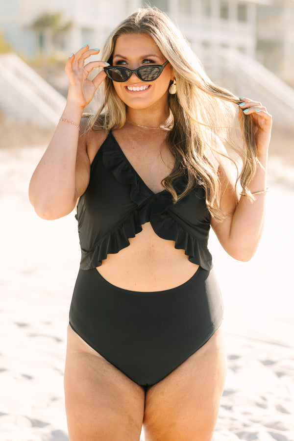 Plus Size black one-piece swimsuit with a front cutout, ruffle trim, and adjustable corset back.