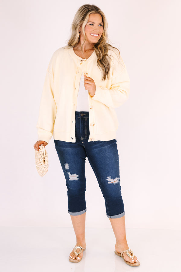 Chic Soul plus size clothing, dark wash capri jeans with front pockets and cuffs at the end of the pants as well as distressed holes on each leg of the pant