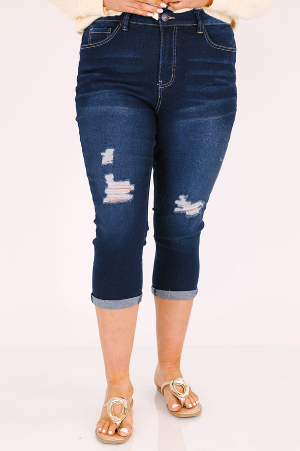 Chic Soul plus size clothing, dark wash capri jeans with front pockets and cuffs at the end of the pants as well as distressed holes on each leg of the pant