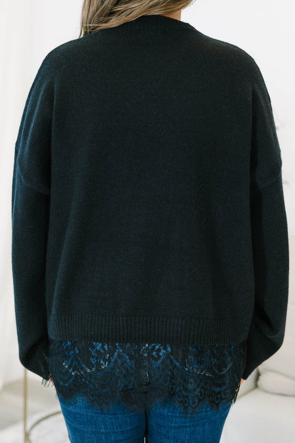 Plus size black crewneck sweater with a relaxed fit and delicate lace trim hem.