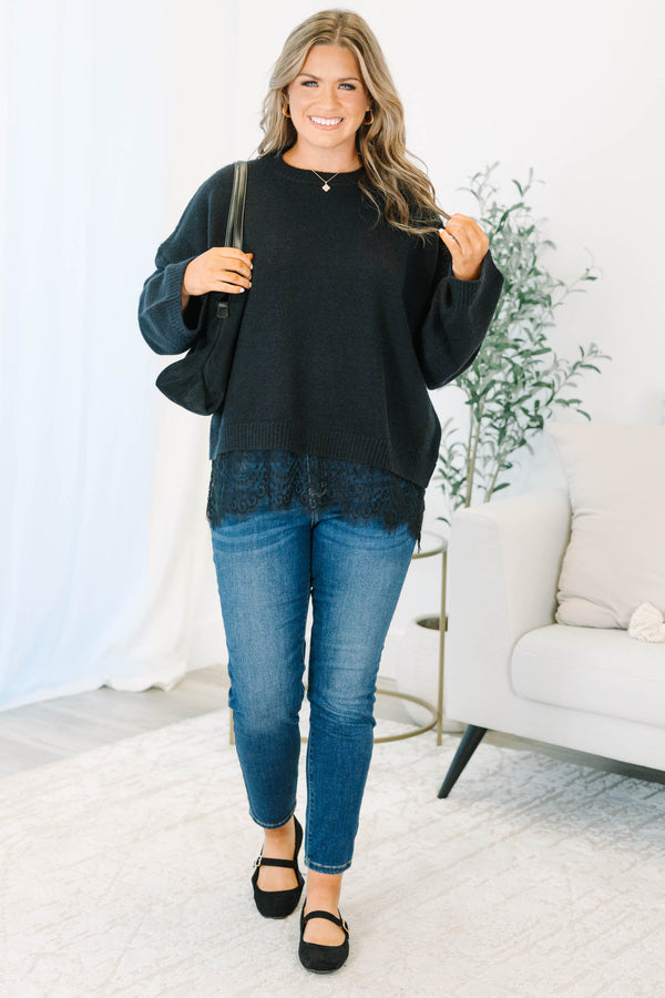 Plus size black crewneck sweater with a relaxed fit and delicate lace trim hem.