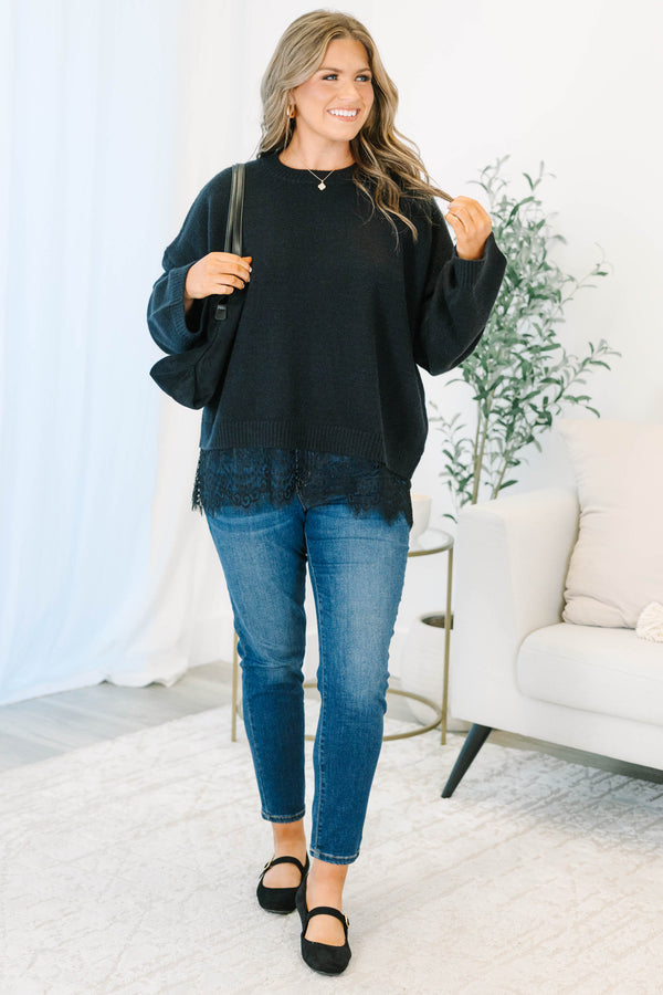 Plus size black crewneck sweater with a relaxed fit and delicate lace trim hem.