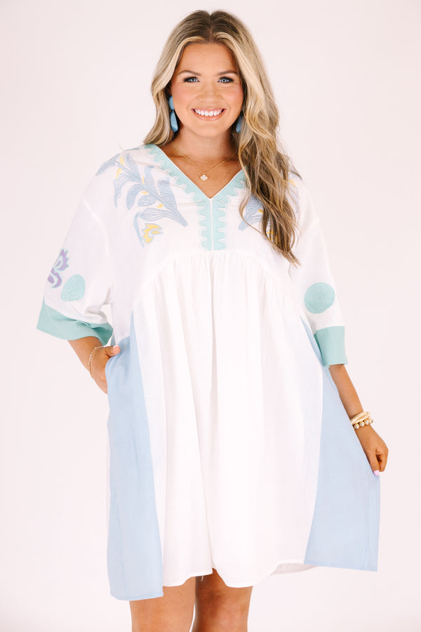 Chic Soul plus size clothing, white knee length dress with seafoam accents on the side of the dress at the end of the sleeves and a seafoam floral pattern on the chest and sleeves area as well as half sleeves and a v-neckline 