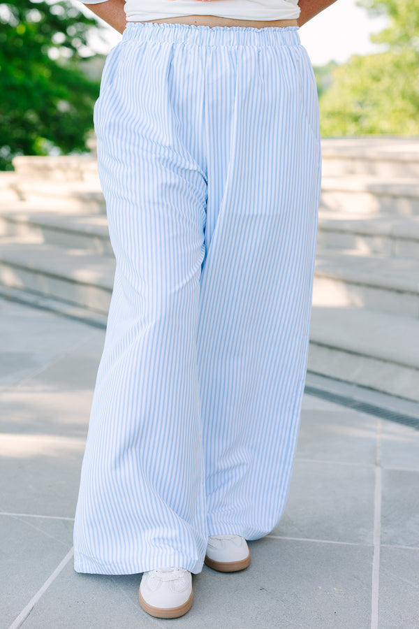 Plus size light blue and white vertical striped wide-leg pants with an elastic waistband and flowy fit.