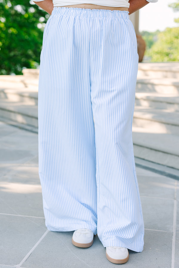 Plus size light blue and white vertical striped wide-leg pants with an elastic waistband and flowy fit.