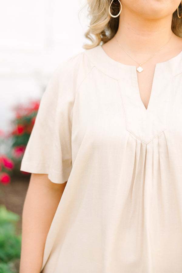 Taupe rayon-linen blend top with a V-neckline, short sleeves, and pleated front detail.