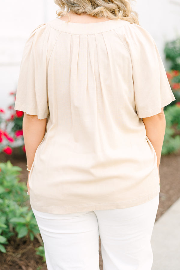Back view of a taupe rayon-linen blend top with short sleeves and pleated back detailing.