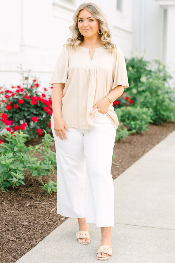 Taupe rayon linen blend top with a v-neckline, relaxed short sleeves, and a pleated front.