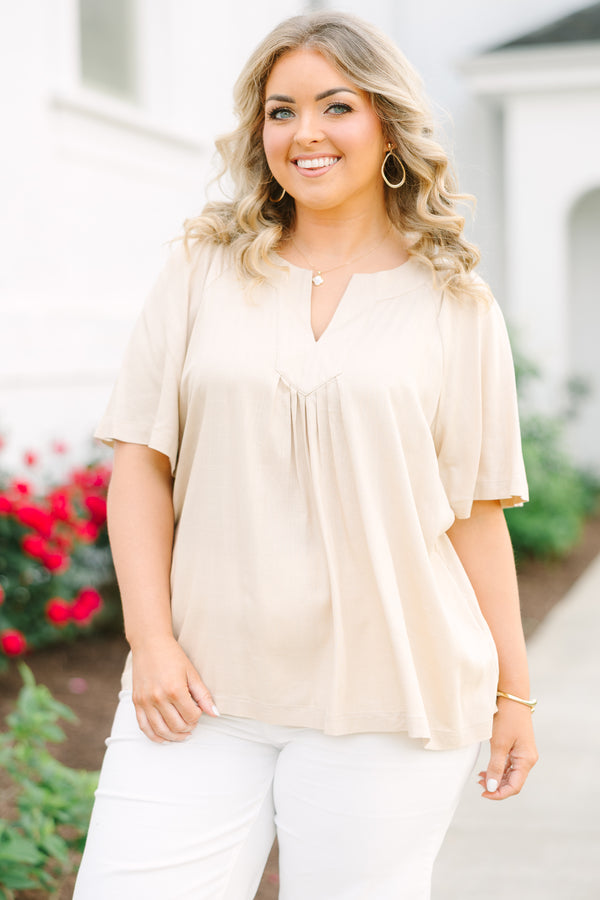 Taupe rayon linen blend top with a v-neckline, relaxed short sleeves, and pleated front detail.
