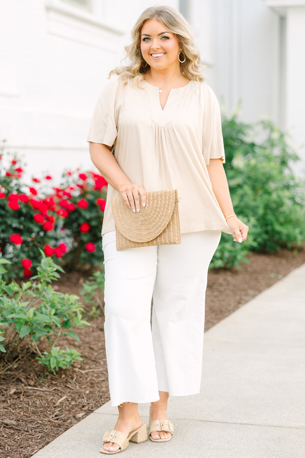 Taupe rayon-linen blend top with a V-neckline, pleated front, and relaxed short sleeves.
