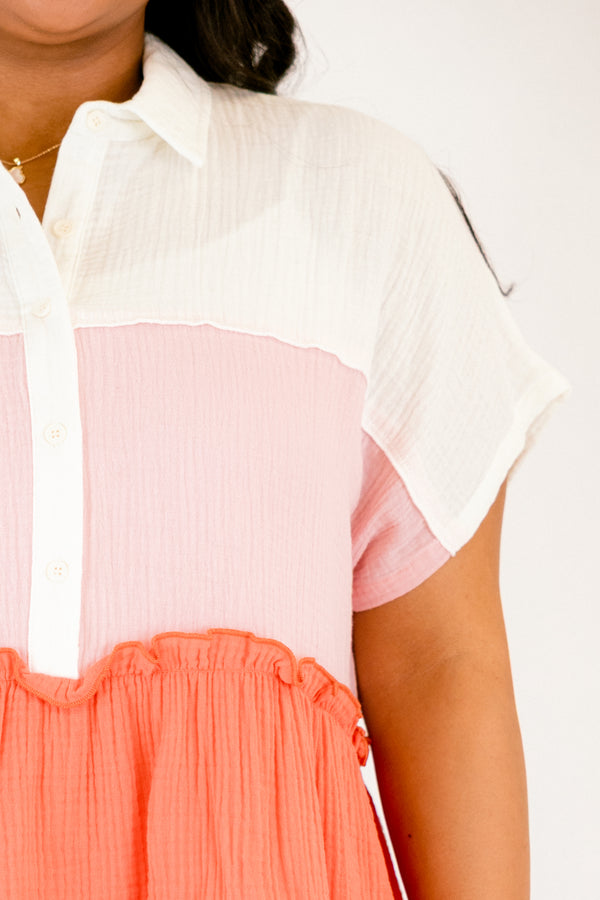 Chic Soul plus size clothing, orange layered top with a white layer on the shoulder and beginning of the chest area a light pink layer on from the top of the chest to the bottom and a orange ruffle layer on the end of the shirt as well as buttons going down to the bottom of the chest and a collar 