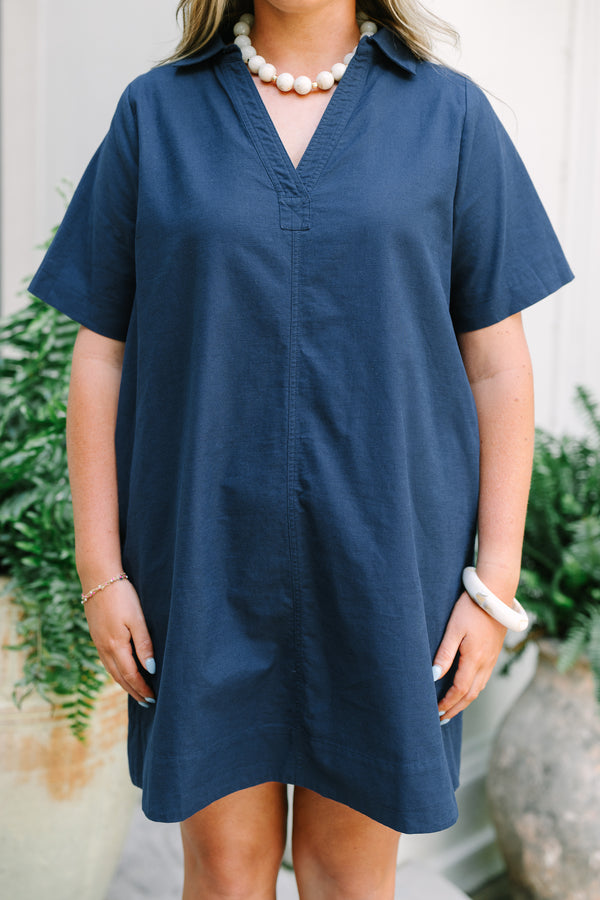 Chic Soul Plus Size Clothing, a short navy blue dress with short sleeves and a collared V-neck. Features side-seam pockets. 