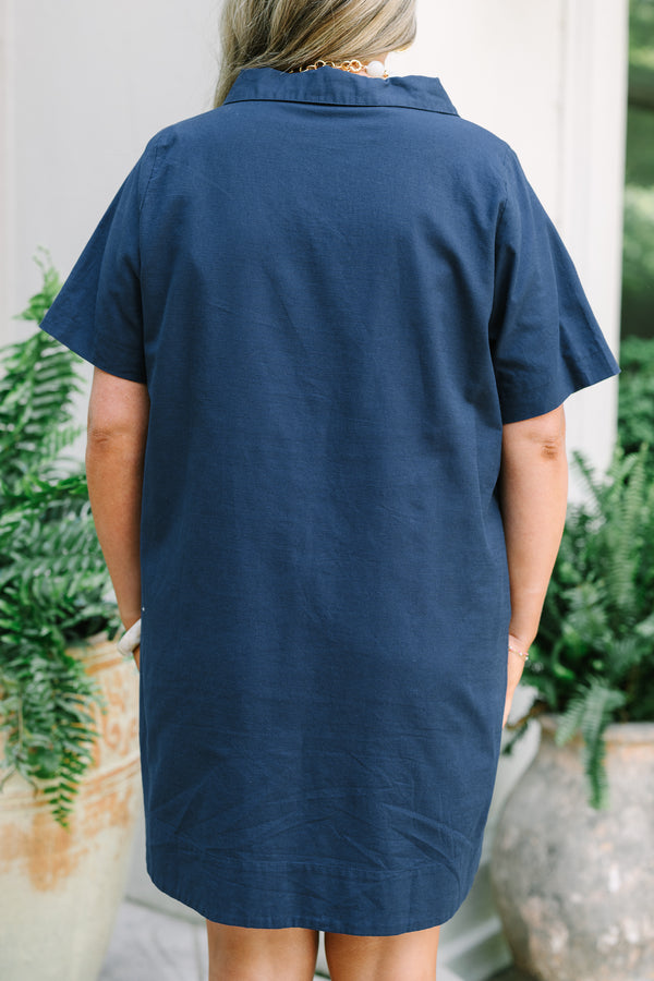 Chic Soul Plus Size Clothing, a short navy blue dress with short sleeves and a collared V-neck. Features side-seam pockets. 