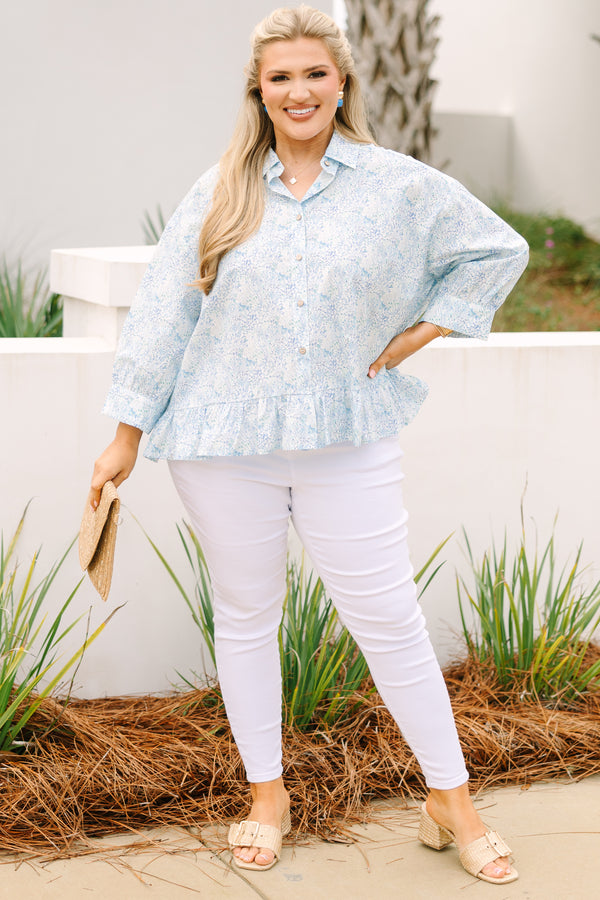 Chic Soul plus size clothing, cerulean top with long sleeves and buttons going down the center of the top as well as a ruffle detail at the bottom of the top and a thin floral pattern throughout 