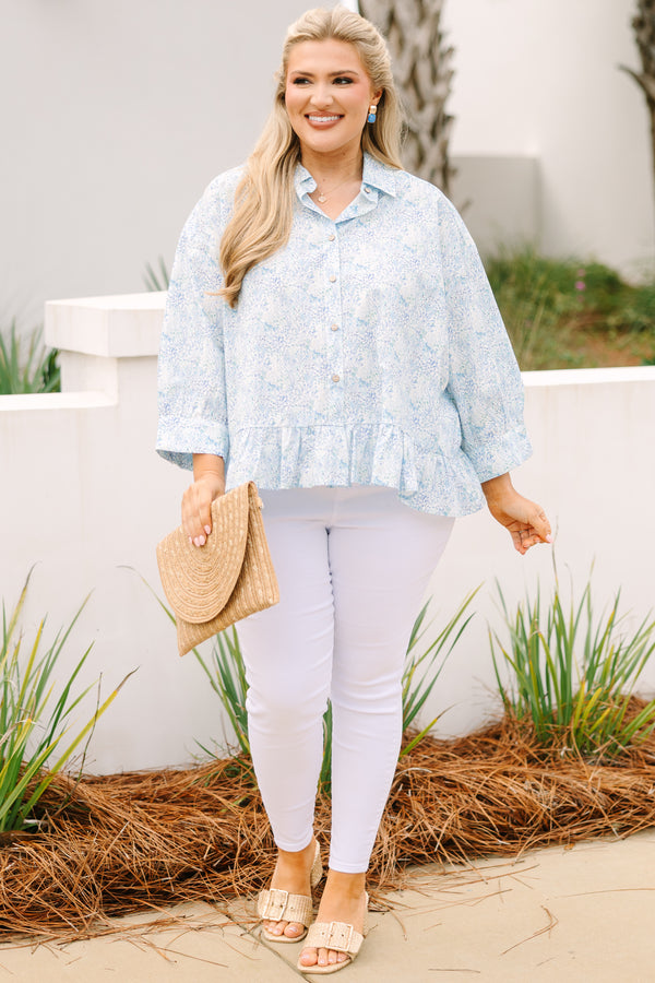 Chic Soul plus size clothing, cerulean top with long sleeves and buttons going down the center of the top as well as a ruffle detail at the bottom of the top and a thin floral pattern throughout 