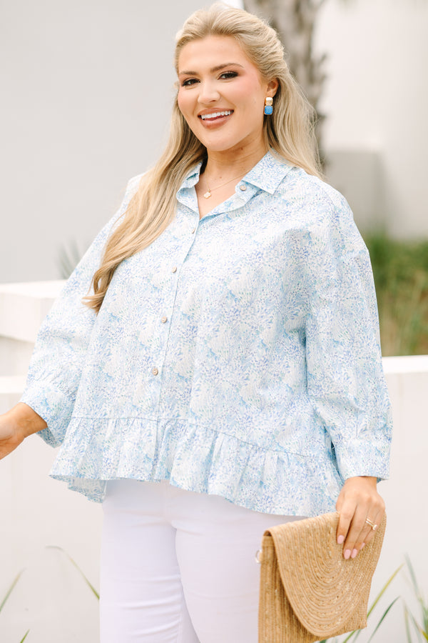 Chic Soul plus size clothing, cerulean top with long sleeves and buttons going down the center of the top as well as a ruffle detail at the bottom of the top and a thin floral pattern throughout 