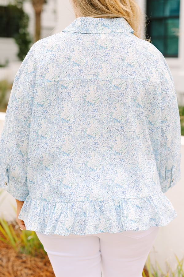Chic Soul plus size clothing, cerulean top with long sleeves and buttons going down the center of the top as well as a ruffle detail at the bottom of the top and a thin floral pattern throughout 