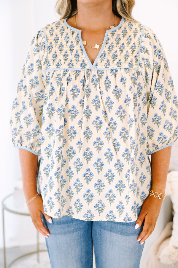 Plus Size cream floral cotton top with blue piping, smocked chest, and three-quarter sleeves.