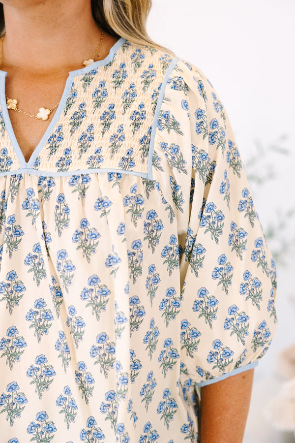 Plus Size cream floral cotton top with blue piping, smocked chest, and three-quarter sleeves.