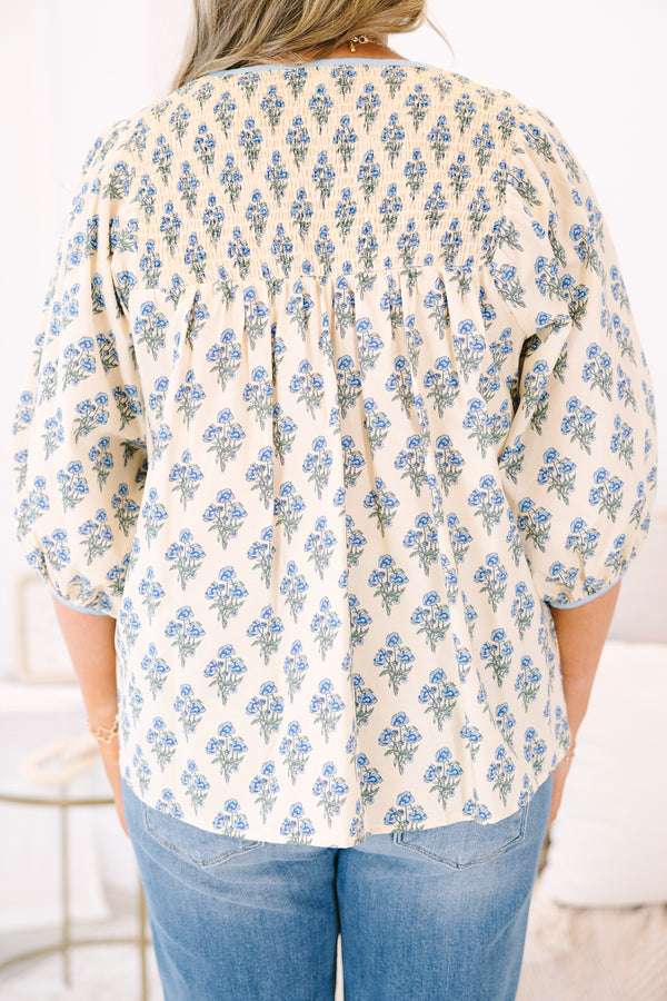 Plus Size cream floral cotton top with blue piping, smocked chest, and three-quarter sleeves.